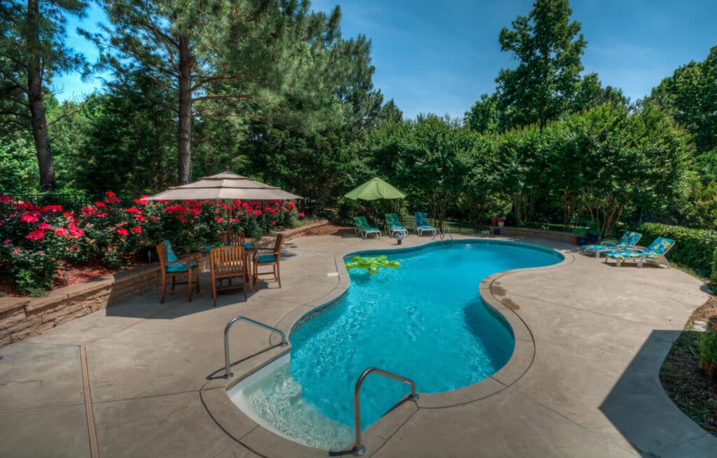 Backyard swimming pool on a sunny day. okc swimming pool contractor, Viking Pools & Outdoor Living.